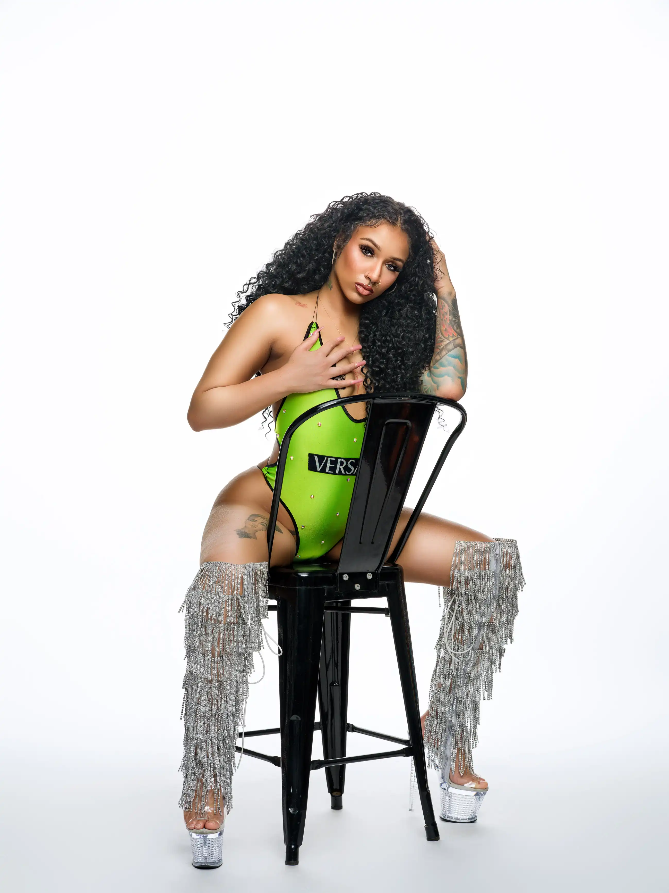 Confident boudoir pose in green bodysuit