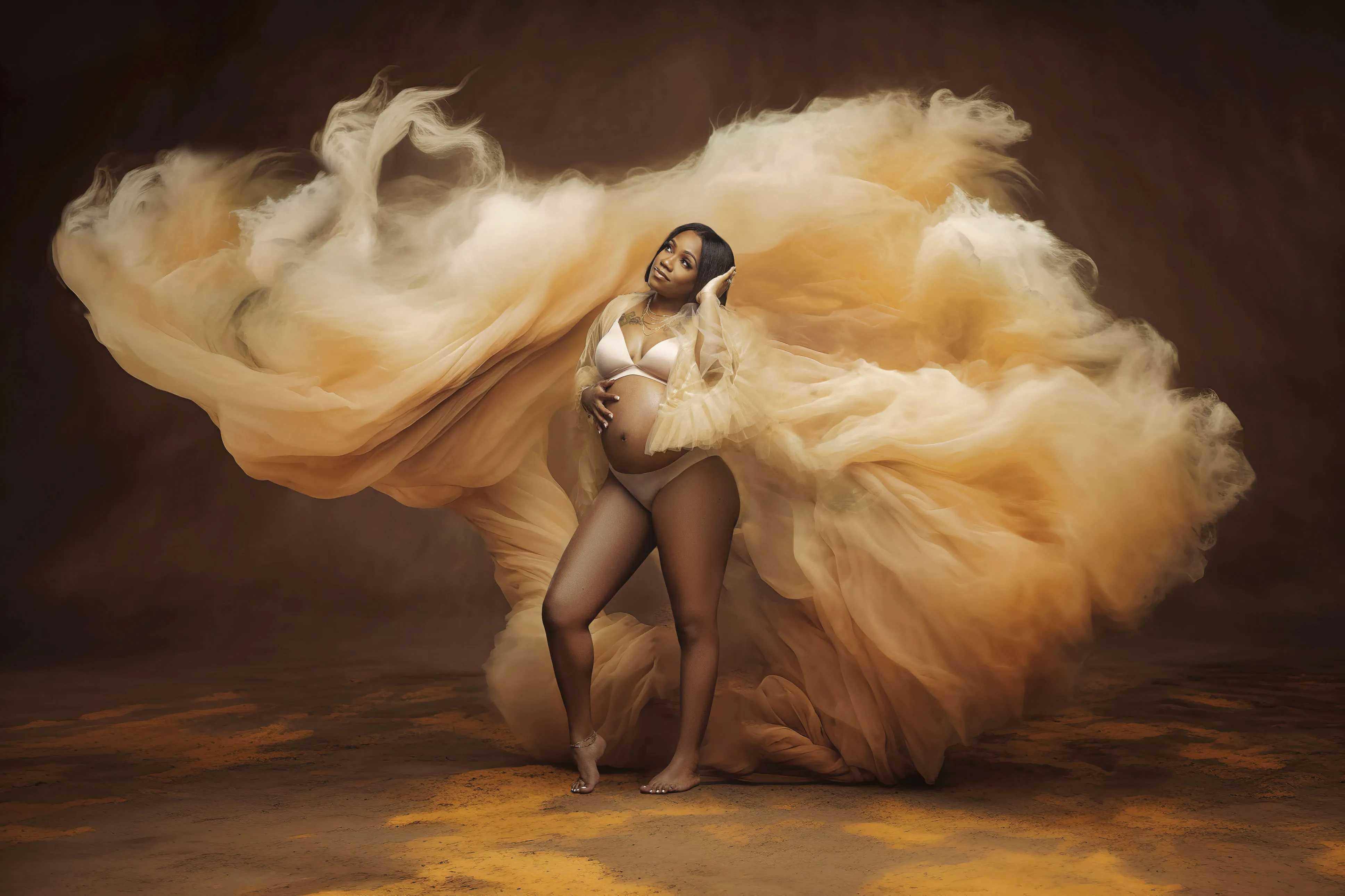 Artistic studio maternity portrait flowing golden fabric Suffolk VA