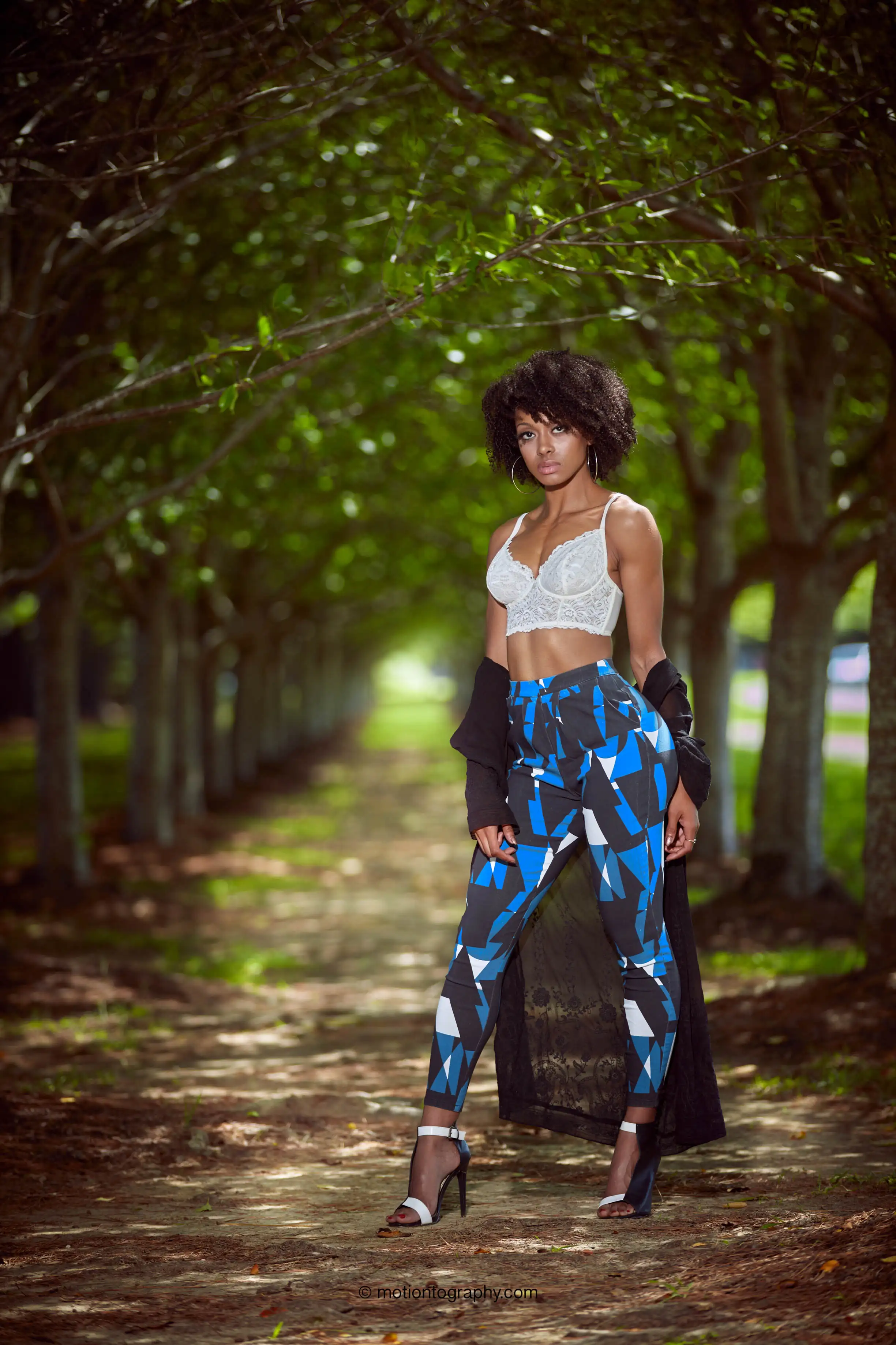 On location forest path photo woman colorful leggings white top