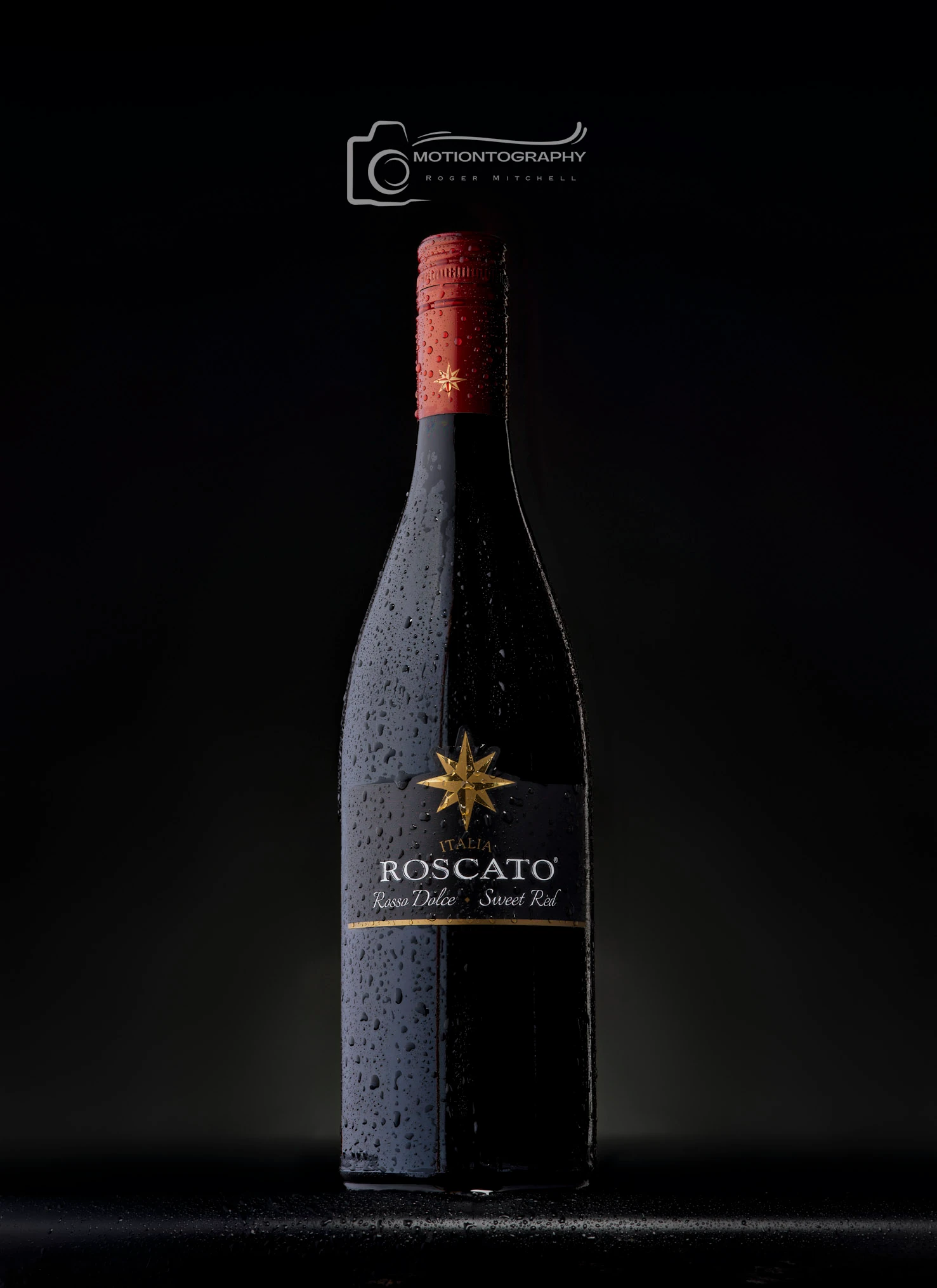 Close-up of an Italian Roscato sweet red wine bottle with water droplets against a dark background