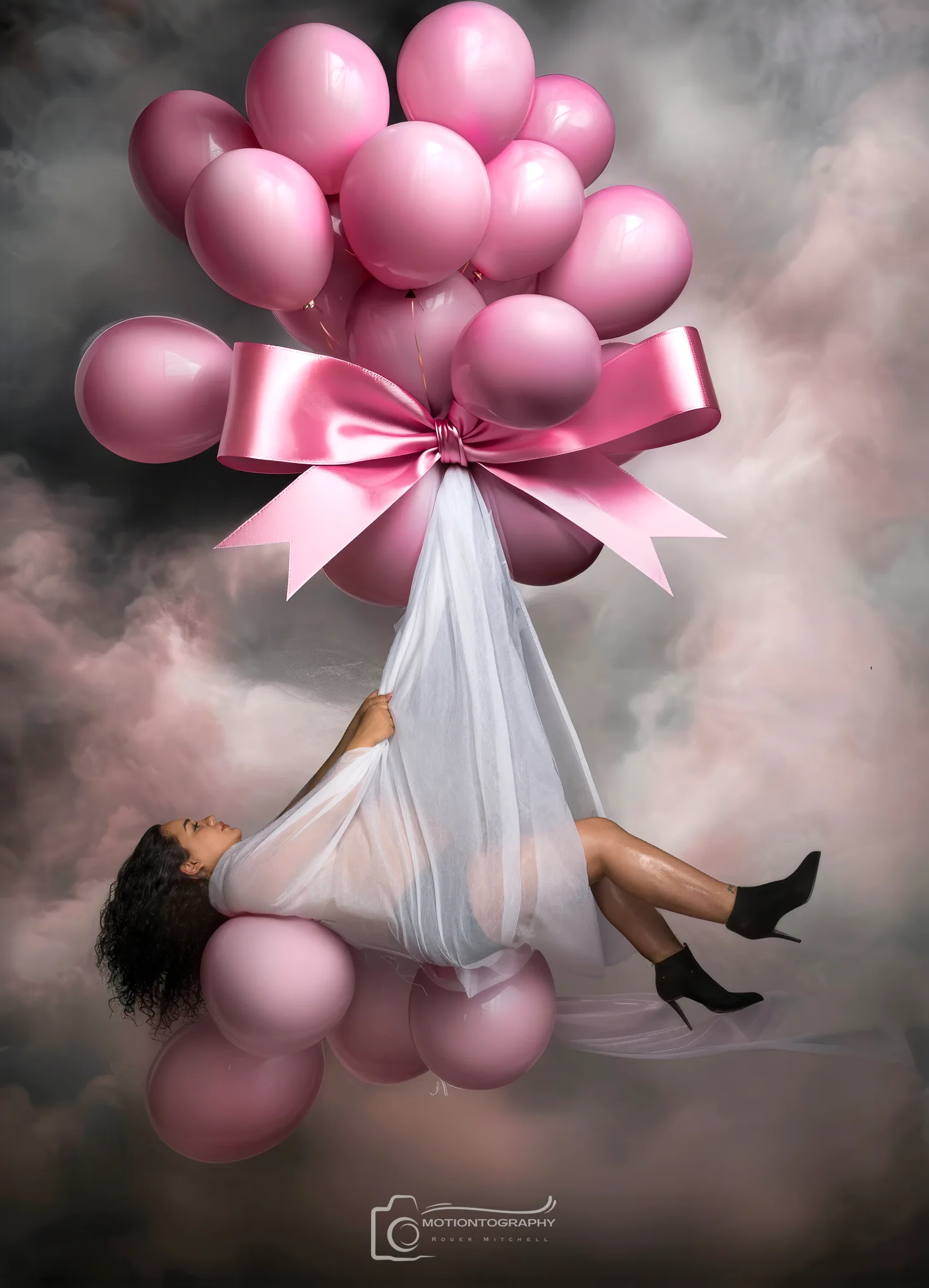 Sheer white gown maternity portrait with pink balloon